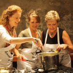 three women cooking holiday tradition